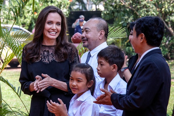 SIEM REAP, CAMBODIA - FEBRUARY 18:  Angelina Jolie (left) and producer Rithy Panh (center) chat with actors before holding a press conference ahead of the premiere of their new film "First They Killed My Father" set up at the Raffles Grand Hotel D'Angkor on February 18, 2017 in Siem Reap, Cambodia. Angelina Jolie is in Siem Reap for the world premiere of her new movie, "First They Killed my Father," a Netflix-produced adaption of the autobiography by the same name penned by Loung Ung, who lived through the Khmer Rouge regime as a young child. The film will be screened Saturday night in the Angkor Wat temple complex, and released later this year on Netflix. (Photo by Omar Havana/Getty Images)