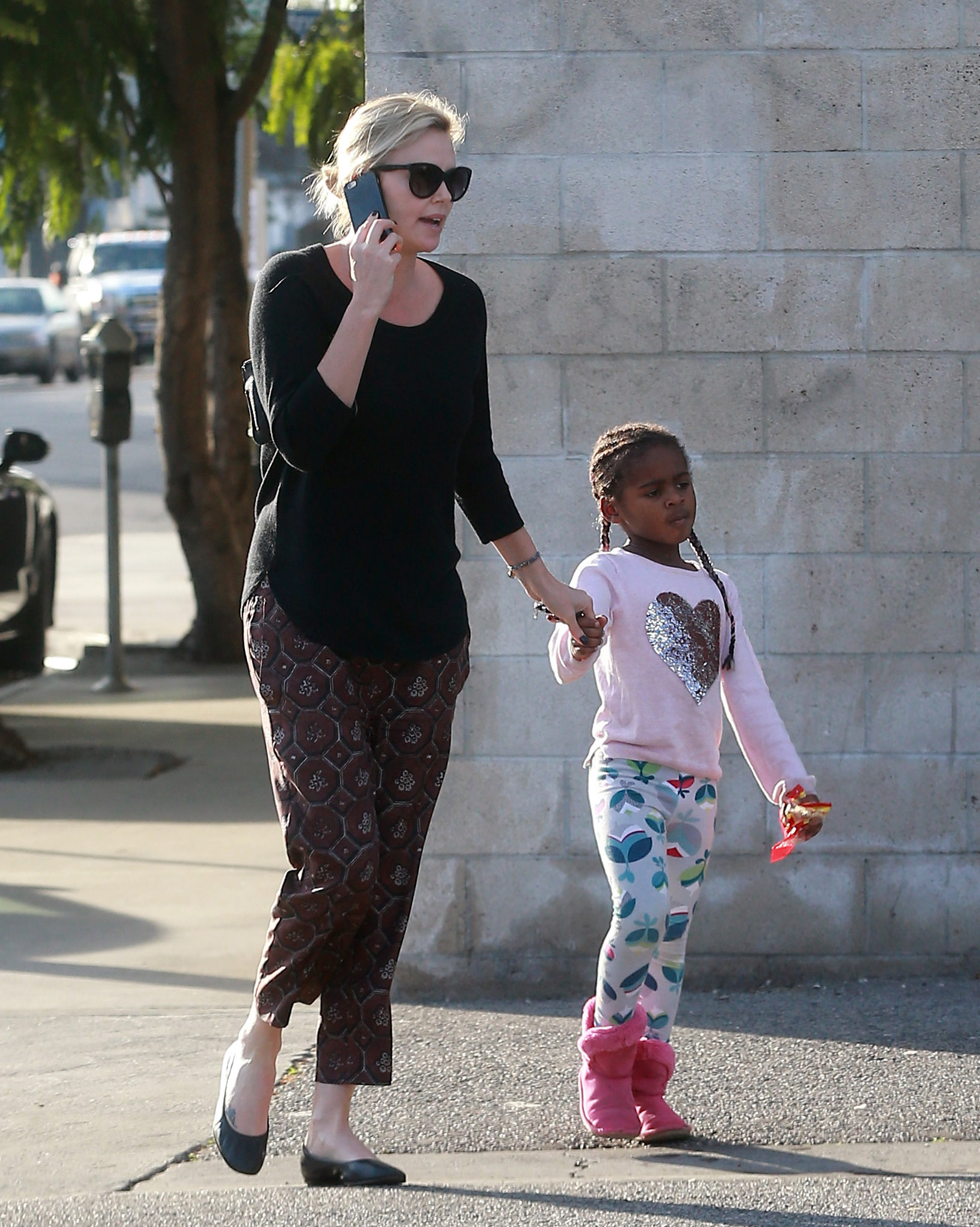 Exclusive... 52284924 Actress and busy mom Charlize Theron was spotted stopping by a gas station with her son Jackson while out running errands in Los Angeles, California on January 17, 2017. Charlize continues to dress her son in girl's clothing including a pink shirt with a silver heart, braids in his hair, and even a disney princess backpack. FameFlynet, Inc - Beverly Hills, CA, USA - +1 (310) 505-9876